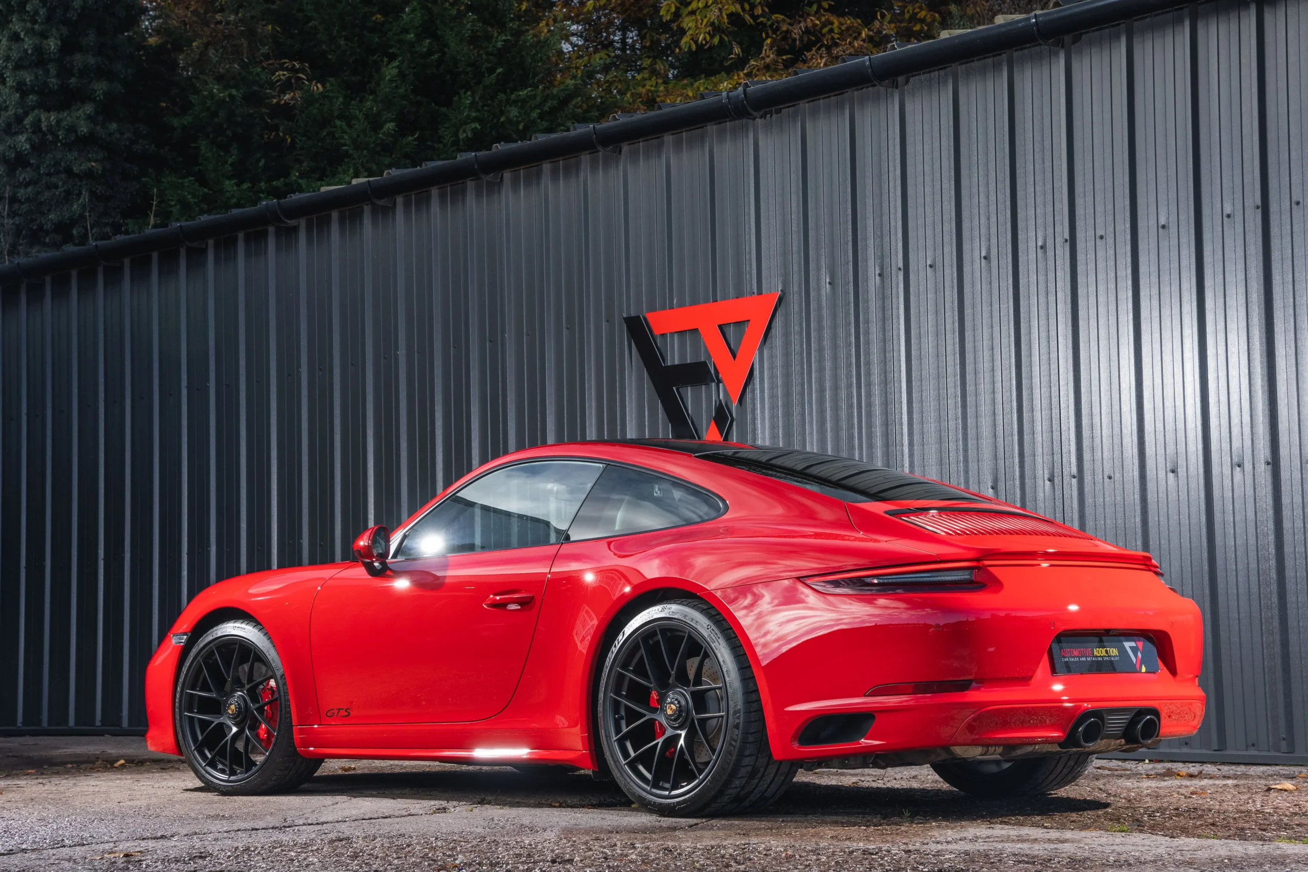 Porsche 911 991.2 Carrera 4 GTS Guards Red rear angled